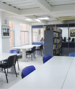 General shot showing bookshelves with books and several desks.