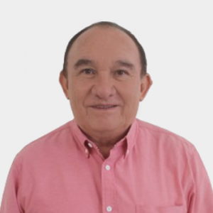 La foto fue tomada en primer plano, fondo blanco y el profesor Gerardo Baustista Ardila está situado en el centro.