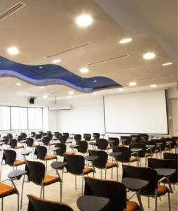 General shot of the classroom showing the desks and the board in the background.