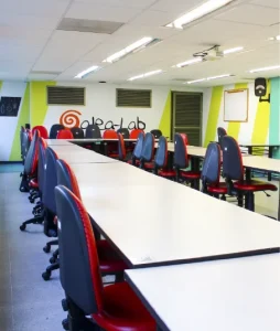 Photograph of the room showing a long table with chairs around it