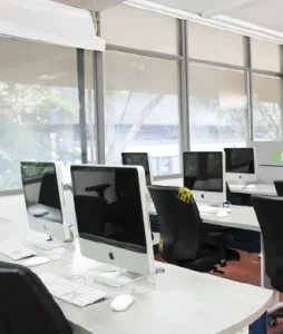 General shot showing desks, each one with its respective computer.