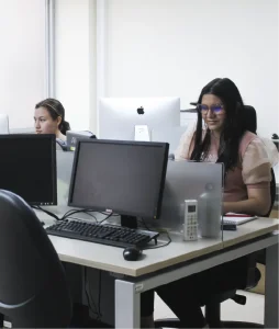 Plano general donde se ven estudiantes trabajando en sus respectivos computadores