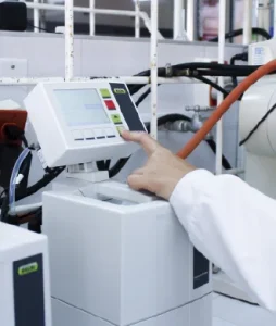 Plano detalle de la mano de un estudiante manipulando los equipos del laboratorio