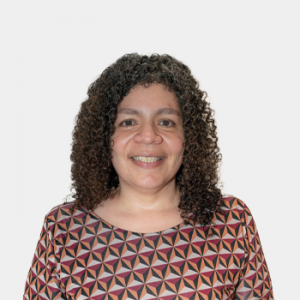 The photo was taken in the foreground, white background and Professor Olga Uribe is located in the center.