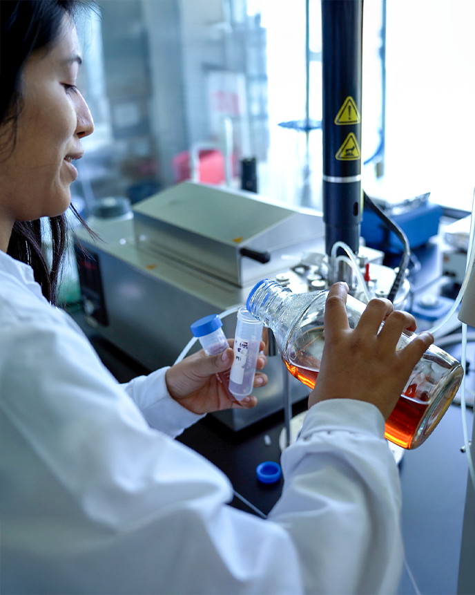 Graduate student working with fluids in the lab