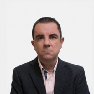 The photo was taken in the foreground, white background and the professor is located in the center.