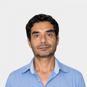 Photo in foreground; professor Ernesto Aguilera centered with a white background.