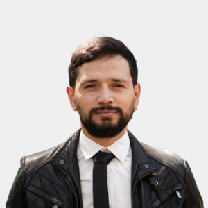 Photo in foreground; professor Juan Reyes centered with a white background.