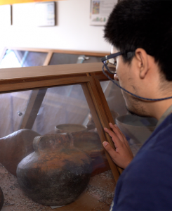 Student viewing a museum display case